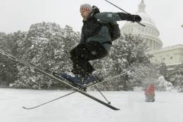 Andrew Kermick, who works on Capitol Hill, goes airborne as he skis in the snow on the West Front of the U.S. Capitol in Washington, Saturday, Dec. 19, 2009. (AP Photo/Alex Brandon)