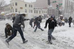 A group takes part in an impromptu snowball fight that took over the intersection of 14th and U Streets during a snow storm in Washington, Saturday, Dec. 19, 2009. The event was organized by a Twitter group calling for people to gather and participate and more then 200 people showed up. (AP Photo/Pablo Martinez Monsivais)