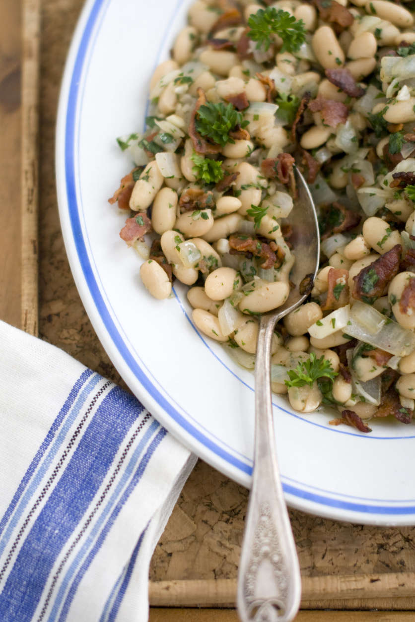 This March 15, 2011 photo shows warm bean and bacon salad in Concord, N.H.  Jacques Pepins salad recipe calls for small white navy beans, but you can substitute any similar variety.   (AP Photo/Matthew Mead)