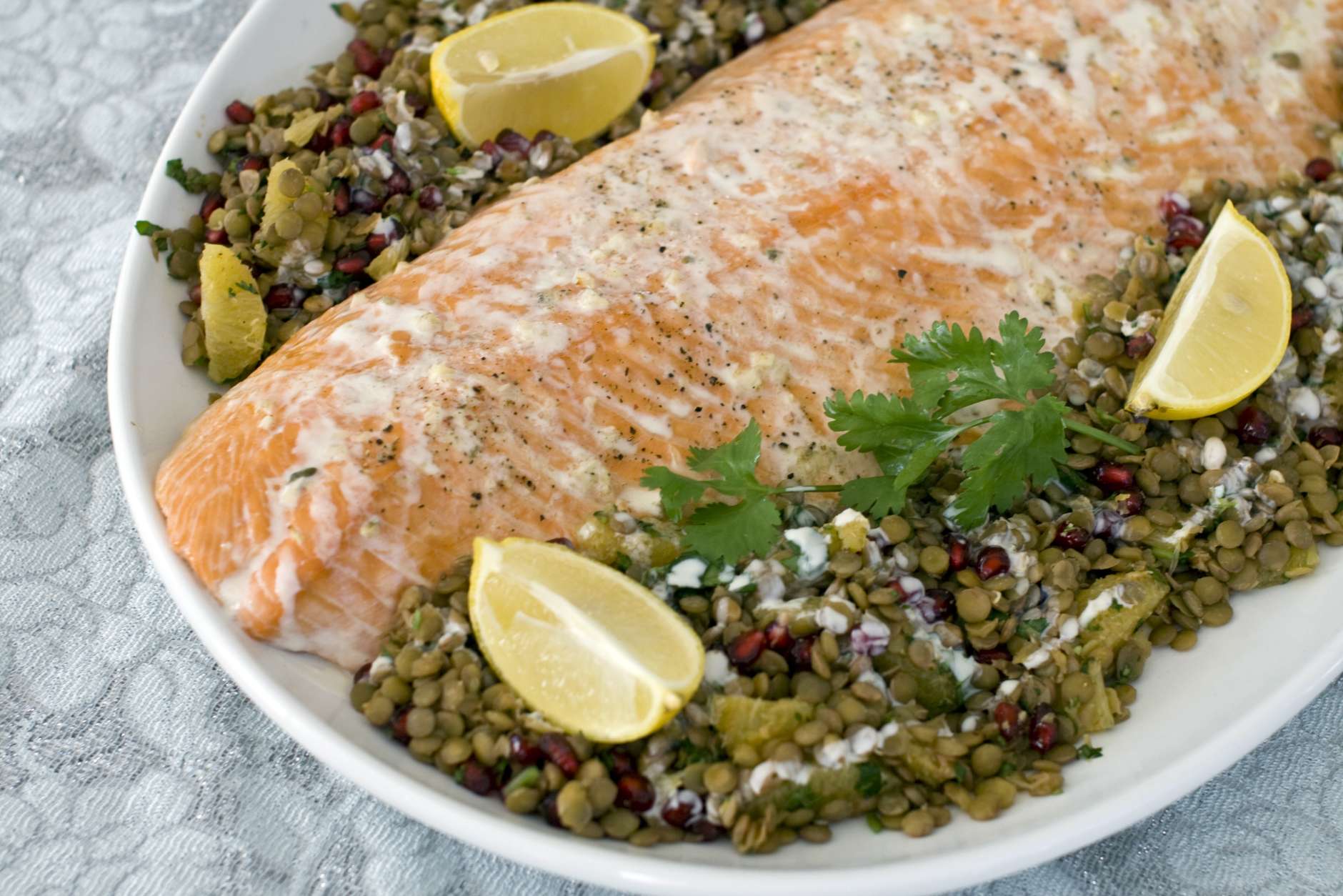 This Nov. 21, 2011 photo shows roasted salmon with warm lentil salad in Concord, N.H.   Feeding a crowd this New Years Eve? Consider offering something that is richly savory, but wont weigh down the party.    (AP Photo/Matthew Mead)