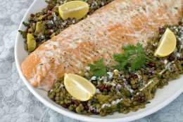This Nov. 21, 2011 photo shows roasted salmon with warm lentil salad in Concord, N.H.   Feeding a crowd this New Years Eve? Consider offering something that is richly savory, but wont weigh down the party.    (AP Photo/Matthew Mead)