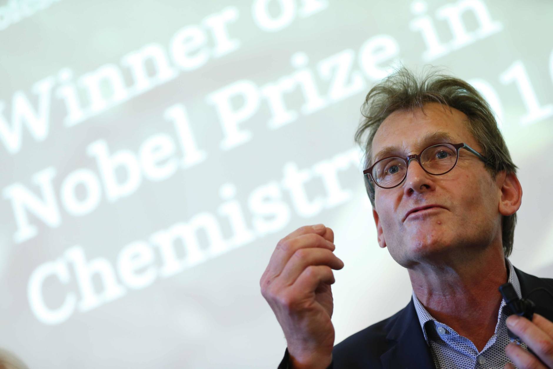 Dutch scientist  Bernard "Ben" Feringa gestures as he speaks during a press conference at the University of Groningen in the Netherlands, Wednesday Oct. 5, 2016 Feringa was one of  the three scientists who won the Nobel Prize in chemistry on Wednesday for developing the world's smallest machines, work that could revolutionise computer technology and lead to a new type of battery. (AP Photo/Peter Dejong)