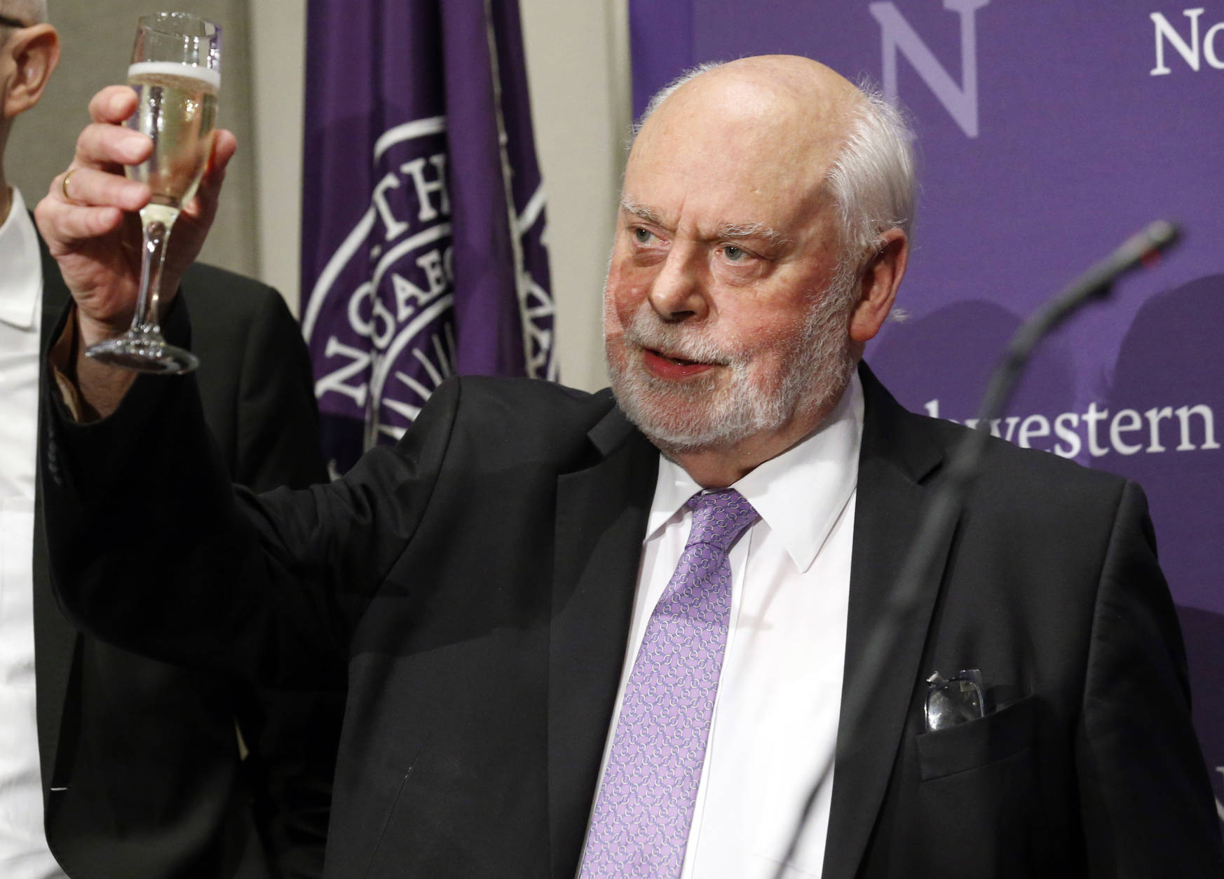 Fraser Stoddart raises his glass for a toast during a news conference at the Rebecca Crown Center at Northwestern University, in Evanston, Ill., Wednesday, Oct. 5, 2016. Stoddart, a Scottish-born chemistry professor at Northwestern University, was awarded the Nobel Prize in chemistry on Wednesday. (AP Photo/Nam Y. Huh)