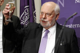 Fraser Stoddart raises his glass for a toast during a news conference at the Rebecca Crown Center at Northwestern University, in Evanston, Ill., Wednesday, Oct. 5, 2016. Stoddart, a Scottish-born chemistry professor at Northwestern University, was awarded the Nobel Prize in chemistry on Wednesday. (AP Photo/Nam Y. Huh)