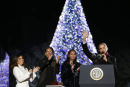 President Barack Obama, first lady Michelle Obama and their daughter Sasha waves and applaud after lighting the 2016 National Christmas Tree at the Ellipse near the White House in Washington, Thursday, Dec. 1, 2016. Also on stage is the host Eva Longoria. (AP Photo/Pablo Martinez Monsivais)