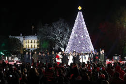 Visitors use their cell phone cameras to capture the moment of the 2016 National Tree lighting. Experts warn consumers should rely only on cellular connections to prevent themselves from being hacked in large crowds. (AP Images)