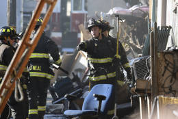 Firefighters assess the scene where a deadly fire tore through a late-night electronic music party in a warehouse in Oakland, Calif., Saturday, Dec. 3, 2016. Officials described the scene inside the warehouse, which had been illegally converted into artist studios, as a death trap that made it impossible for many partygoers to escape the Friday night fire. (AP Photo/Josh Edelson)