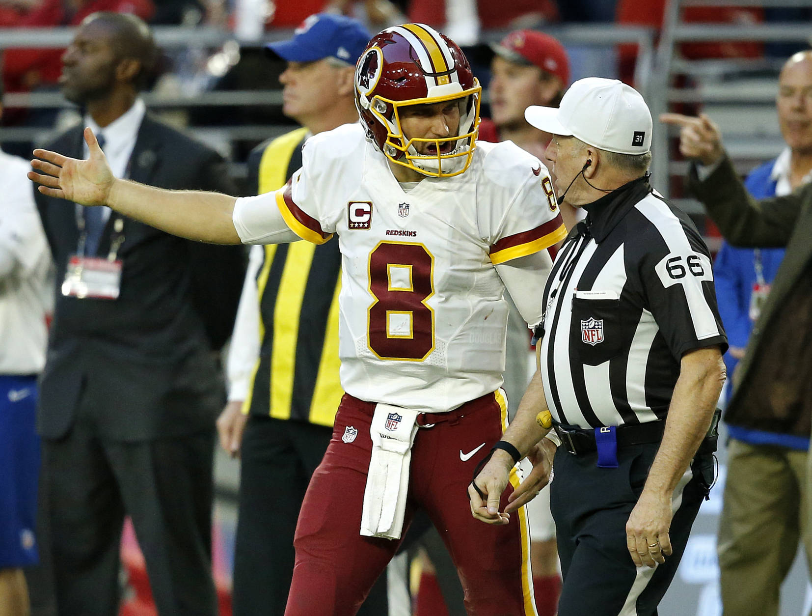 Washington Redskins quarterback Kirk Cousins (8) argues a call with referee Walt Anderson (66) during the second half of an NFL football game against the Arizona Cardinals, Sunday, Dec. 4, 2016, in Glendale, Ariz. (AP Photo/Ross D. Franklin)