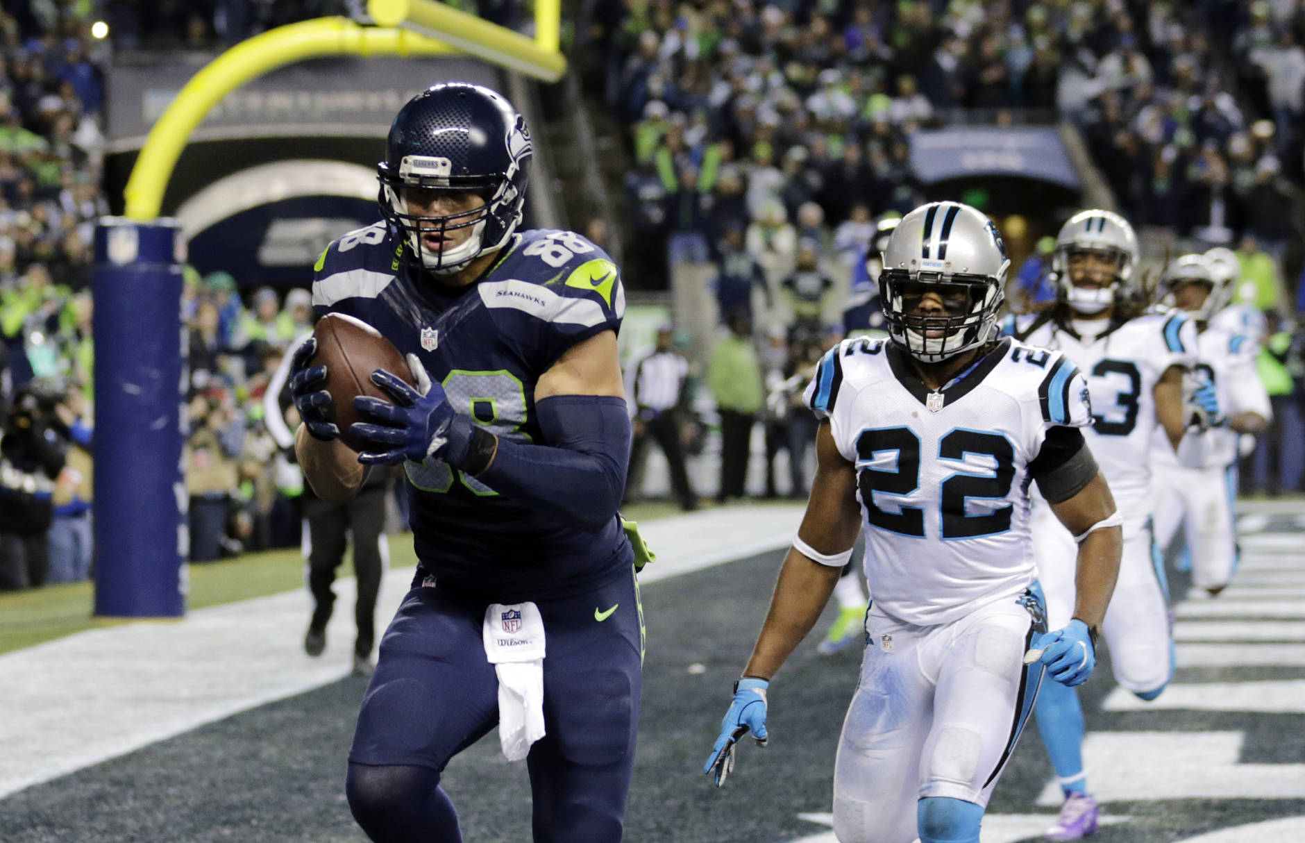 Seattle Seahawks' Jimmy Graham, left, runs for a touchdown after a reception in front of Carolina Panthers' Michael Griffin (22) in the second half of an NFL football game, Sunday, Dec. 4, 2016, in Seattle. (AP Photo/Stephen Brashear)d
