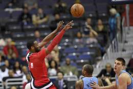 Washington Wizards guard John Wall (2) passes the ball over Denver Nuggets guard Jameer Nelson (1), bottom center, and Denver Nuggets forward Nikola Jokic, of Serbia, bottom right, during the first half of an NBA basketball game, Thursday, Dec. 8, 2016, in Washington. (AP Photo/Nick Wass)