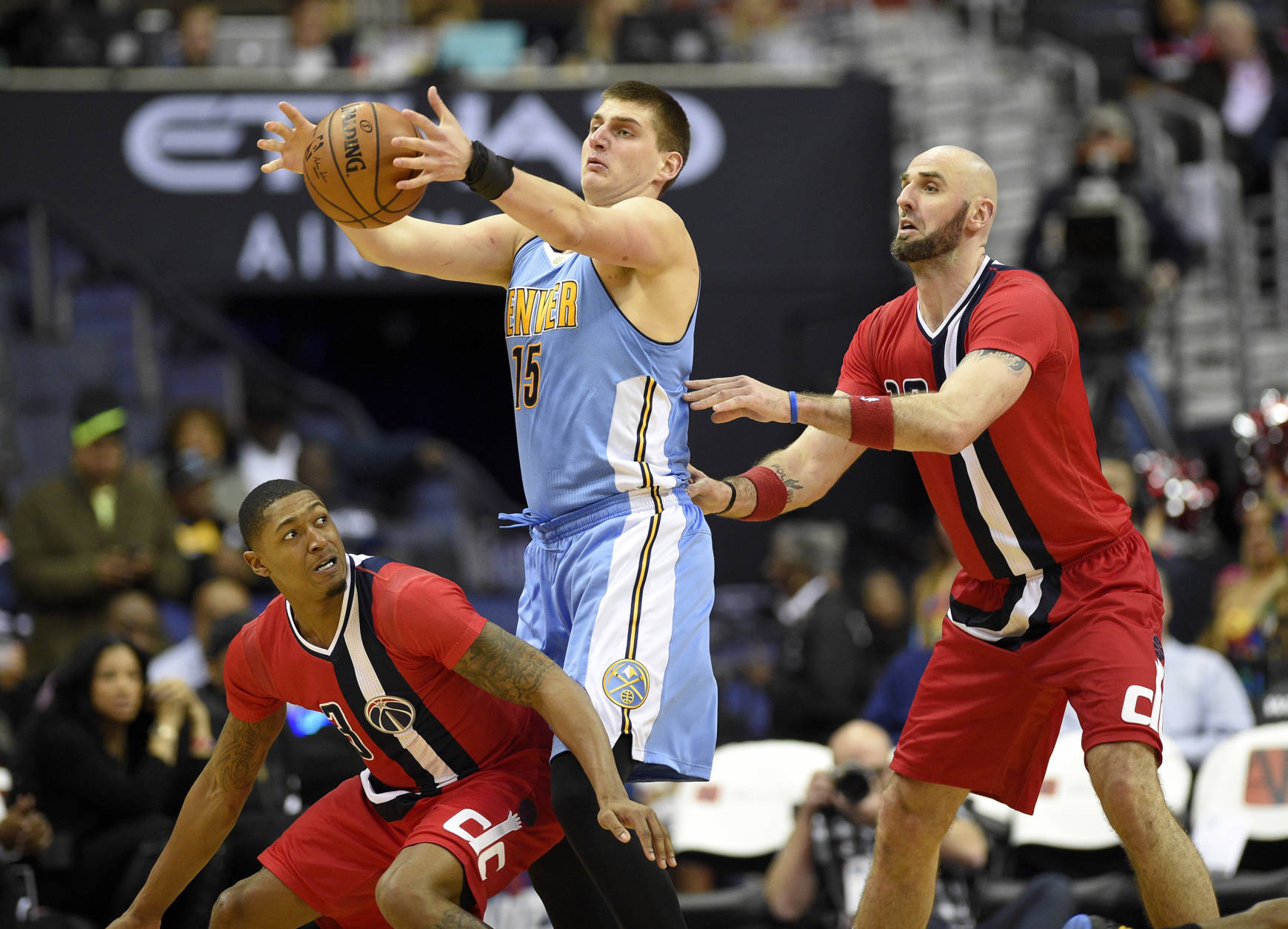 Denver Nuggets forward Nikola Jokic, of Serbia, (15) grabs the ball against Washington Wizards center Marcin Gortat, of Poland, right, and guard Bradley Beal, lower left, during the second half of an NBA basketball game, Thursday, Dec. 8, 2016, in Washington. The Wizards won 92-85. (AP Photo/Nick Wass)