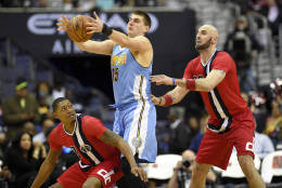 Denver Nuggets forward Nikola Jokic, of Serbia, (15) grabs the ball against Washington Wizards center Marcin Gortat, of Poland, right, and guard Bradley Beal, lower left, during the second half of an NBA basketball game, Thursday, Dec. 8, 2016, in Washington. The Wizards won 92-85. (AP Photo/Nick Wass)