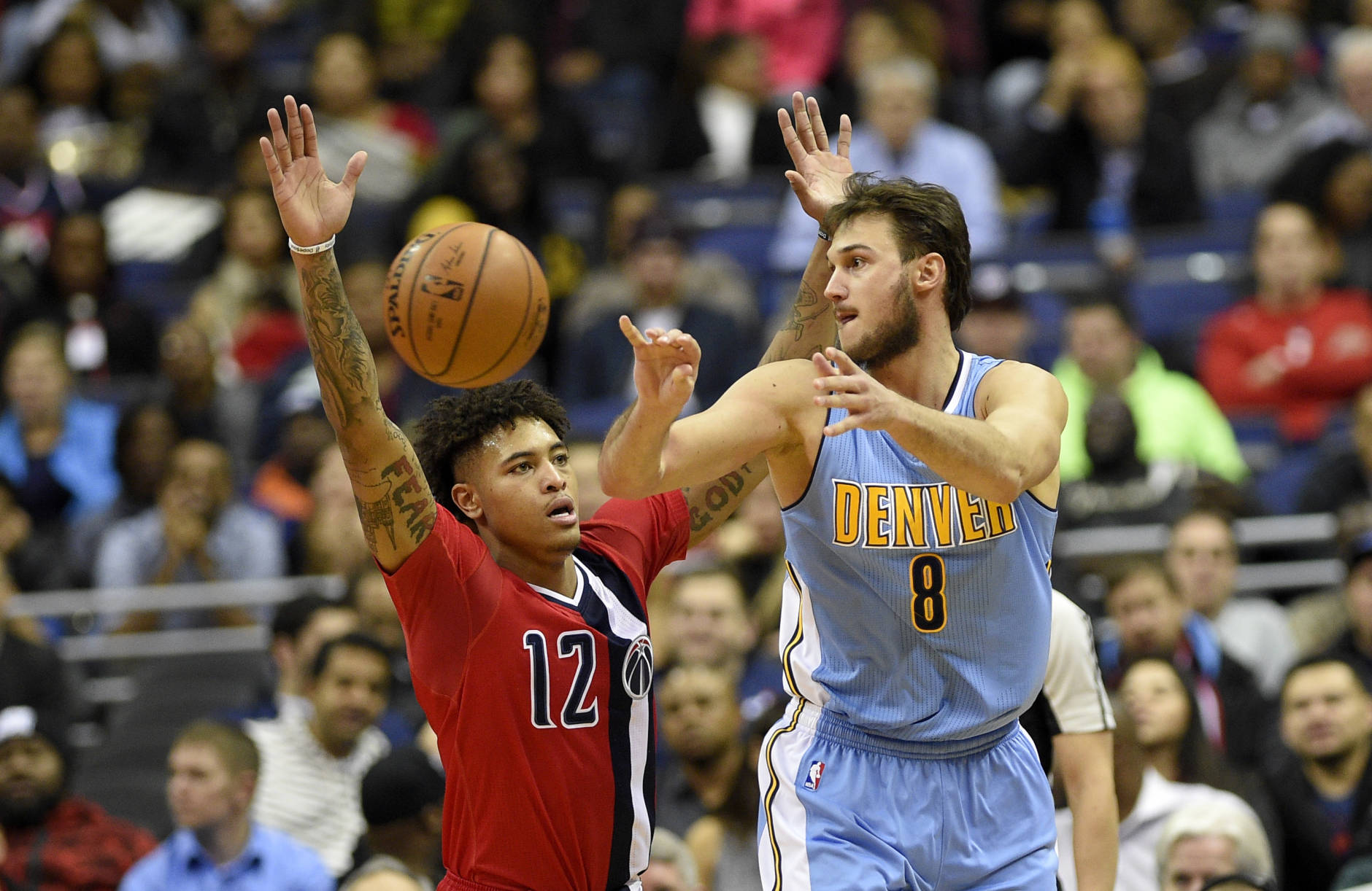 Denver Nuggets forward Danilo Gallinari, of Italy, (8) passes the ball past Washington Wizards forward Kelly Oubre Jr. (12) during the second half of an NBA basketball game, Thursday, Dec. 8, 2016, in Washington. The Wizards won 92-85. (AP Photo/Nick Wass)