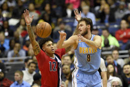 Denver Nuggets forward Danilo Gallinari, of Italy, (8) passes the ball past Washington Wizards forward Kelly Oubre Jr. (12) during the second half of an NBA basketball game, Thursday, Dec. 8, 2016, in Washington. The Wizards won 92-85. (AP Photo/Nick Wass)