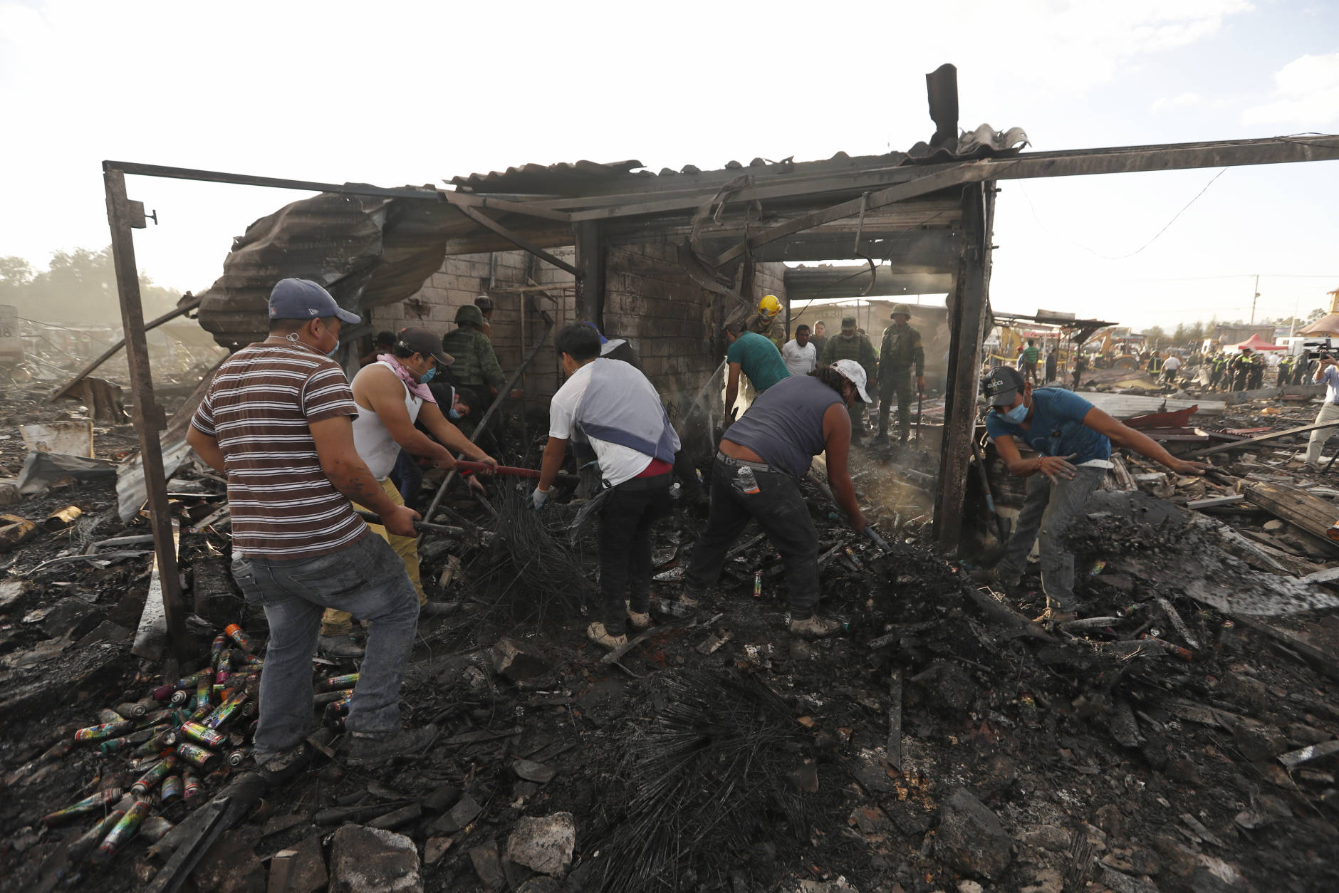 Local residents comb through ashes and rubble at the scorched ground of Mexico's best-known fireworks market after an explosion explosion ripped through it, inTultepec, Mexico, Tuesday, Dec. 20, 2016. National Civil Protection Coordinator Luis Felipe Puente told Milenio TV that dozens were hurt but he had no immediate report of any fatalities at the open-air San Pablito Market in Tultepec, in the State of Mexico. (Eduardo Verdugo/AP Photo)
