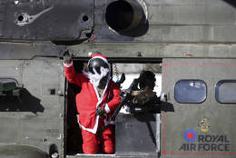 A British airman dressed as Santa Claus waves during a soccer match between British and German soldiers in Christmas day at Resolute Support HQ, in Kabul, Afghanistan, Sunday, Dec. 25, 2016. NATO soldiers, Resolute Support mission played a soccer match marking the 102 years anniversary of WW1 in Kabul. The match ended up with British winning the match by (1-0). (AP Photos/Massoud Hossaini)