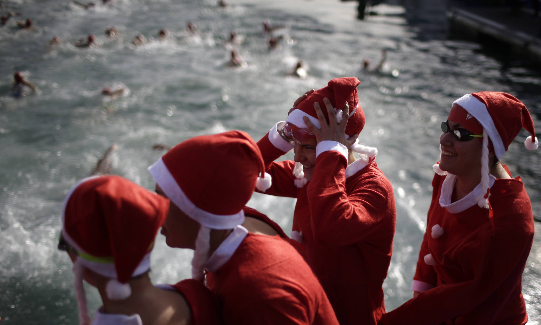 Women dressed as Santa Claus prepare to jump into the Mediterranean sea as they take part in the Copa Nadal in the Spanish port of Barcelona, Sunday, Dec. 25, 2016. The Copa Nadal (Christmas Cup) is a traditional swimming competition that takes place in Barcelona every December 25th, where participants swim 200 meters in the open sea in the port of Barcelona. (AP Photo/Manu Fernandez)