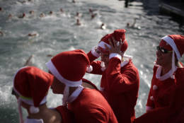 Women dressed as Santa Claus prepare to jump into the Mediterranean sea as they take part in the Copa Nadal in the Spanish port of Barcelona, Sunday, Dec. 25, 2016. The Copa Nadal (Christmas Cup) is a traditional swimming competition that takes place in Barcelona every December 25th, where participants swim 200 meters in the open sea in the port of Barcelona. (AP Photo/Manu Fernandez)