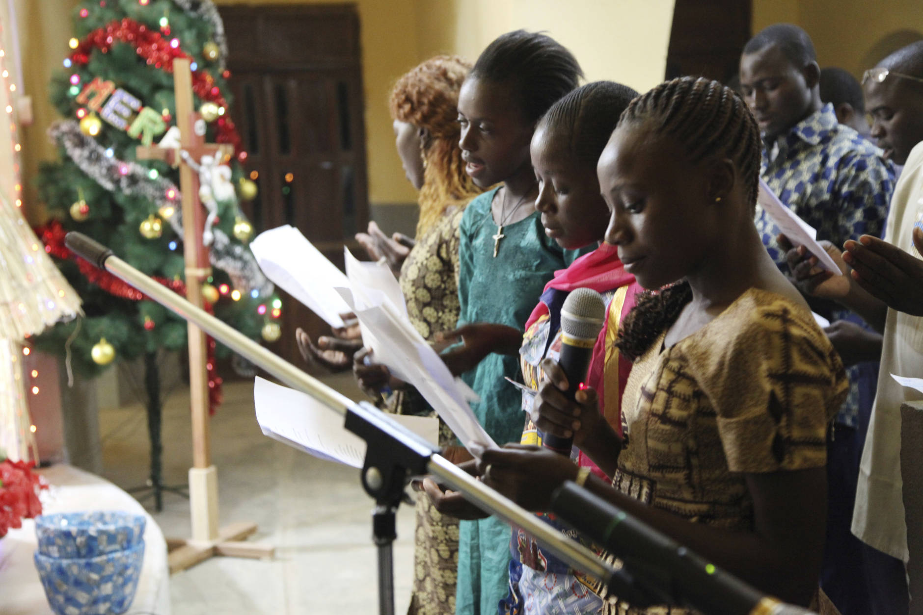 In this photo taken Saturday, Dec. 24, 2016, Catholic faithfuls sing during a mass to celebrate Christmas at Philippe Amore Catholic Church in Goa, Mali. Just four years ago strict Islamic law was in force in this town, but Christians have returned to rebuild their congregation that fled the jihadist occupation. (AP Photo/Baba Ahmed)