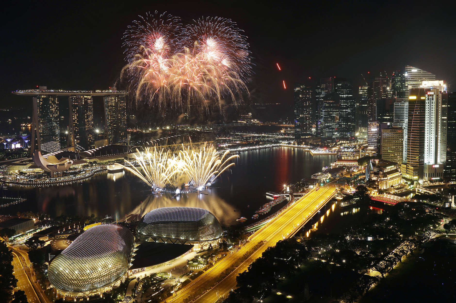 Fireworks explode above Singapore's financial district at the stroke of midnight to mark the New Year's celebrations on Sunday, Jan. 1, 2017, in Singapore. (AP Photo/Wong Maye-E)