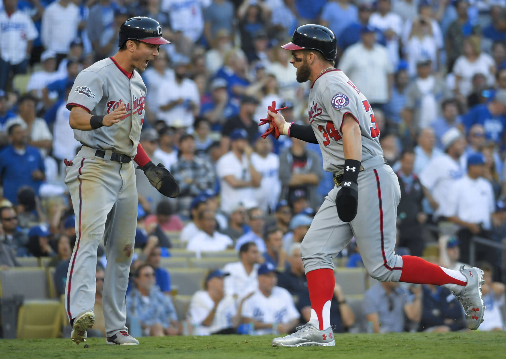 Washington Nationals' Bryce Harper, right, celebrates with Trea Turner after scoring on the two RBI single by Daniel Murphy during the seventh inning in Game 4 of baseball's National League Division Series against the Los Angeles Dodgers in Los Angeles, Tuesday, Oct. 11, 2016. (AP Photo/Mark J. Terrill)