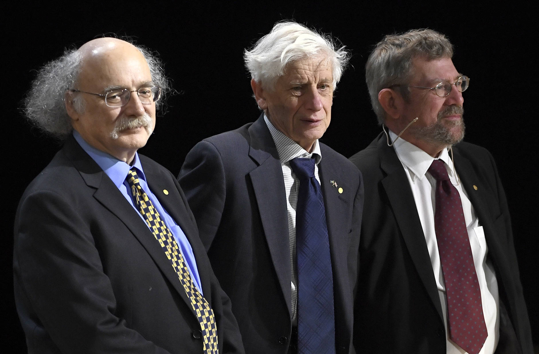 The Nobel Prize in Physics laureates F. Duncan M. Haldane, left, David J. Thouless and J. Michael Kosterlitz, right, attend their Nobel lectures at the Aula Magna lecture hall at the Stockholm University in Stockholm, Sweden, Thursday Dec. 12, 2016. (Claudio Bresciani/TT via AP)