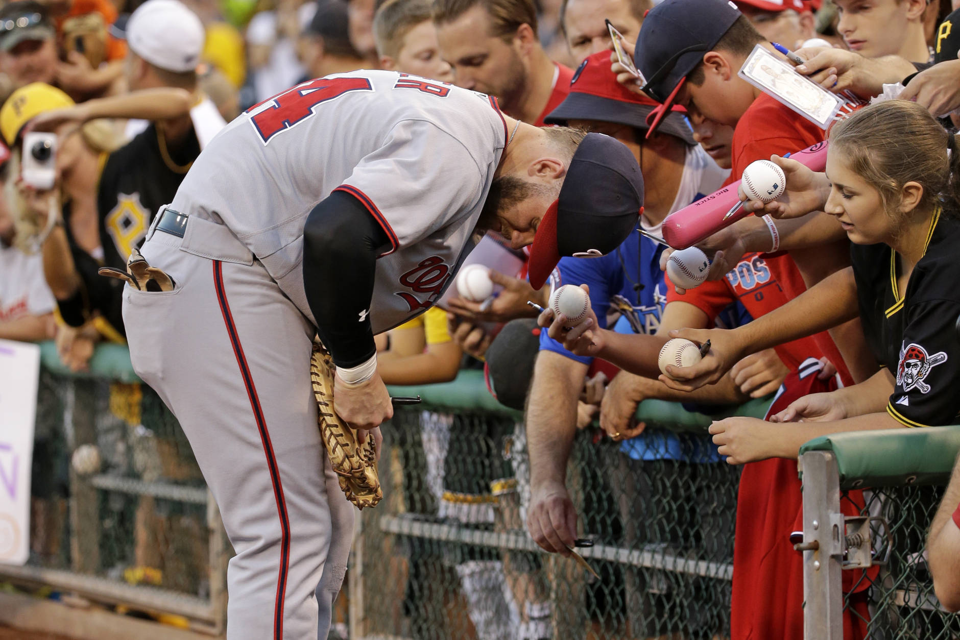 Washington Nationals' Bryce Harper signs autographs before a baseball game against the Pittsburgh Pirates in Pittsburgh, Friday, Sept. 23, 2016. (AP Photo/Gene J. Puskar)
