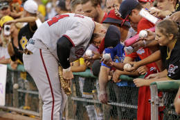 Washington Nationals' Bryce Harper signs autographs before a baseball game against the Pittsburgh Pirates in Pittsburgh, Friday, Sept. 23, 2016. (AP Photo/Gene J. Puskar)