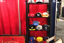Apparel offerings from American Needle, one of the oldest companies set up at the Trade Show. (WTOP/Noah Frank)