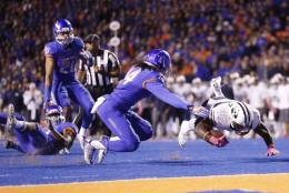 BYU running back Squally Canada falls short of a touchdown after being brought down by Boise State safety Chanceller James (left, on ground) during the second half of an NCAA college football game in Boise, Idaho, Thursday, Oct. 20, 2016. Boise State won 28-27. (AP Photo/Otto Kitsinger)