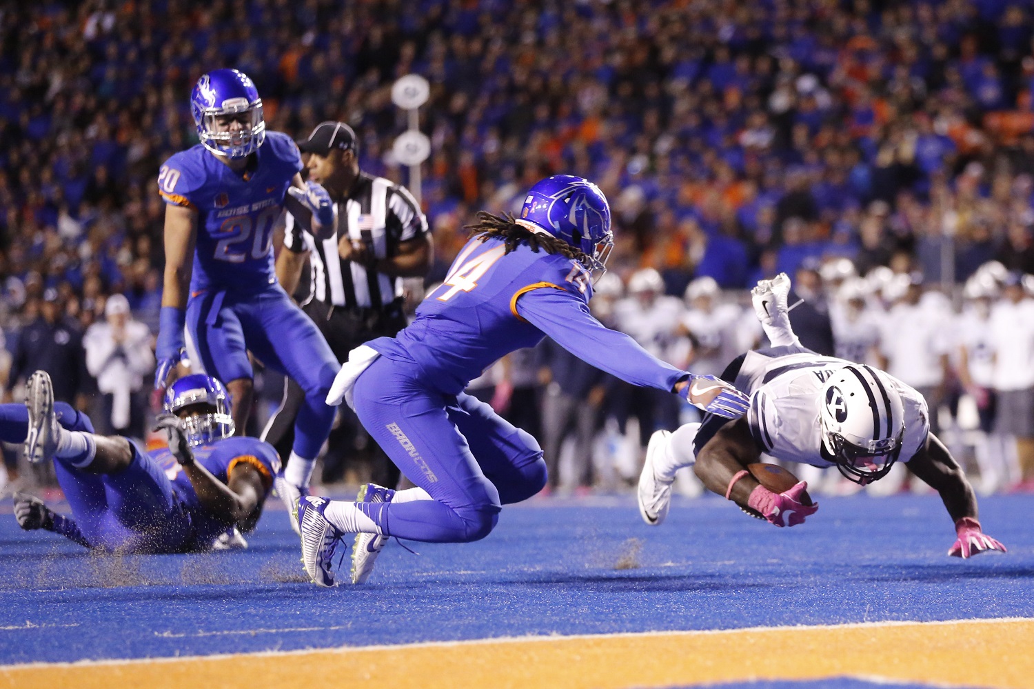 BYU running back Squally Canada falls short of a touchdown after being brought down by Boise State safety Chanceller James (left, on ground) during the second half of an NCAA college football game in Boise, Idaho, Thursday, Oct. 20, 2016. Boise State won 28-27. (AP Photo/Otto Kitsinger)