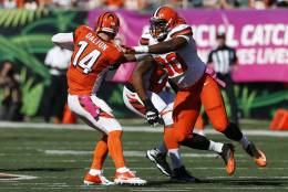 Cincinnati Bengals quarterback Andy Dalton (14) is sacked by Cleveland Browns outside linebacker Emmanuel Ogbah (90) in the first half of an NFL football game, Sunday, Oct. 23, 2016, in Cincinnati. (AP Photo/Gary Landers)