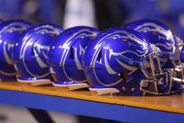 Detail view of Boise State helmets lined up on the bench during the second half of an NCAA college football game against UNLV in Boise, Idaho, Friday, Nov. 18, 2016. Boise State won 42-25. (AP Photo/Otto Kitsinger)