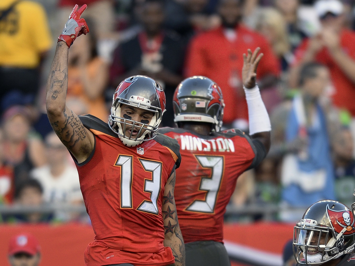 Tampa Bay Buccaneers wide receiver Mike Evans (13) celebrates with quarterback Jameis Winston (3) after Evans caught a 23-yard touchdown reception against the Seattle Seahawks during the second quarter of an NFL football game Sunday, Nov. 27, 2016, in Tampa, Fla. (AP Photo/Jason Behnken)