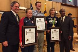 Ashley Nee, Jack Conger and Katie Ledecky received a proclamation the three Olympic atheletes at an event Monday in Silver Spring. Also honored was Helen Maroulis, who was unable to attend. (WTOP/Michelle Basch)