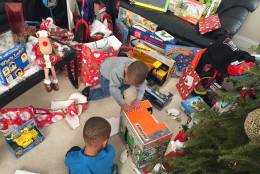 Santa Claus came bearing gifts for these two boys, who were victims of domestic violence. They were reunited with their rescuer on Christmas Day, Sunday, Dec. 25, 2016. (WTOP/John Domen)