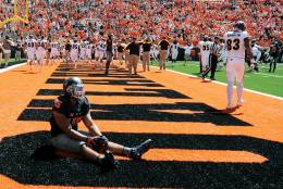 Oklahoma State linebacker Chad Whitener sits alone in the Central Michigan end zone while the Central Michigan team celebrates a last second touchdown by wide receiver Corey Willis, resulting in a 30-27 win over Oklahoma State following an NCAA college football game in Stillwater, Okla., Saturday, Sept. 10, 2016.(AP Photo/Brody Schmidt)