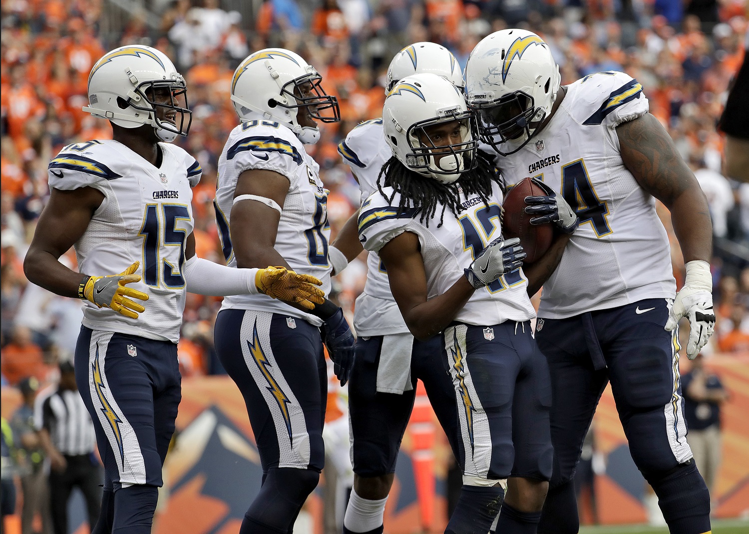 San Diego Chargers wide receiver Travis Benjamin (12) celebrates his touchdown with teammates Orlando Franklin (74) and Dontrelle Inman (15) during the second half of an NFL football game against the Denver Broncos, Sunday, Oct. 30, 2016, in Denver. (AP Photo/Jack Dempsey)