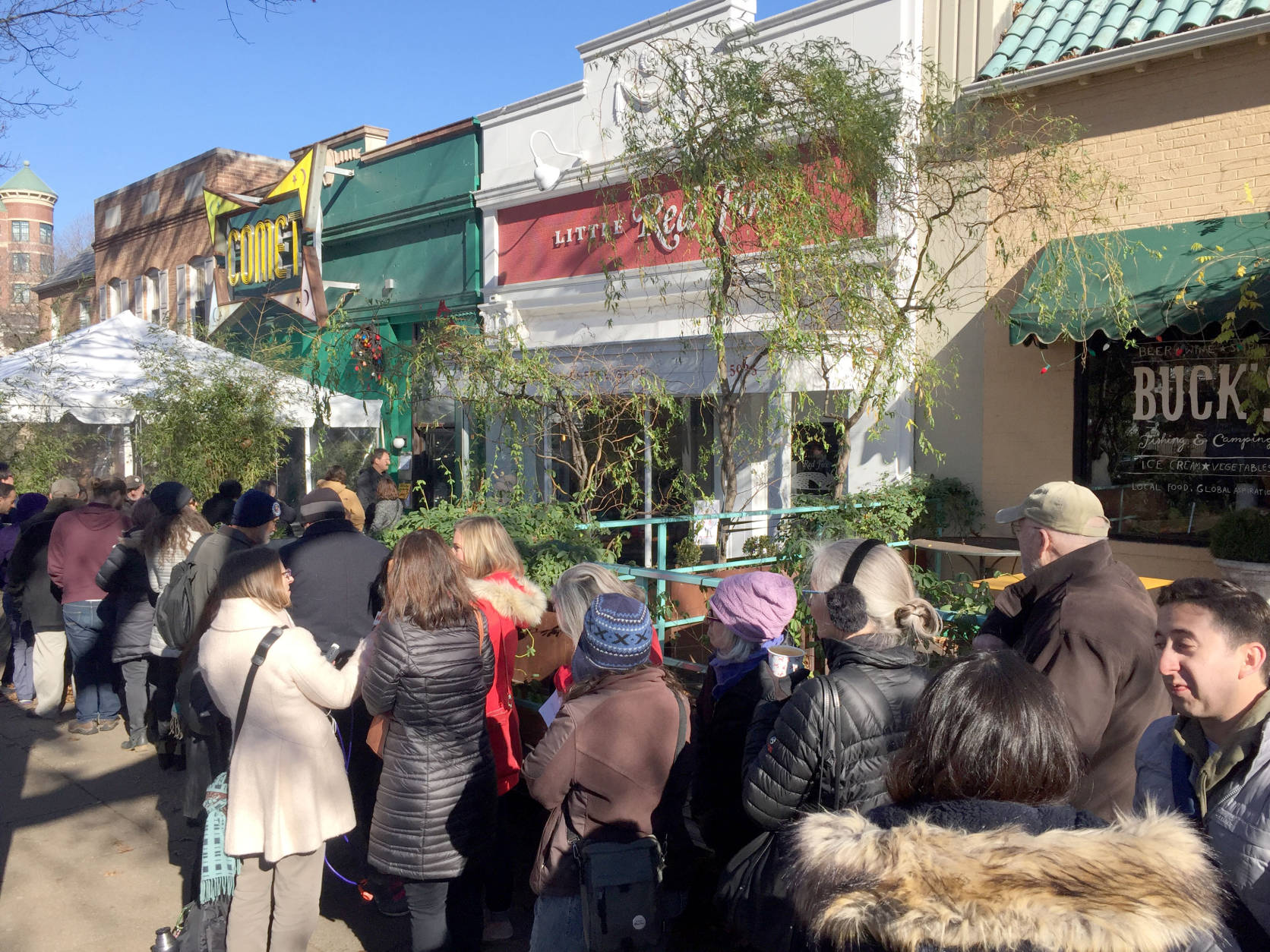 A crowd gathers outside Comet Ping Pong in Northwest, Washington, D.C. on Friday, Dec. 9, 2016. They were there as a show of support after armed man showed up to the restaurant and fired his weapon while trying to investigate a fake news story. (WTOP/Rich Johnson)