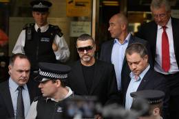 LONDON, ENGLAND - AUGUST 24:  Singer George Michael (C) leaves  Highbury Corner Magistrates Court surrounded by press and police on August 24, 2010 in London, England. Mr Michael pleaded guilty to driving under the influence of drugs and possessing cannabis after he crashed his car into a photo processing shop in London on July 4, 2010.  (Photo by Peter Macdiarmid/Getty Images)
