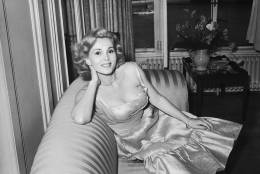 8th July 1952:  Hungarian actress Zsa Zsa Gabor lounges on a sofa in a ruched evening gown.  (Photo by Nixon/Express/Getty Images)