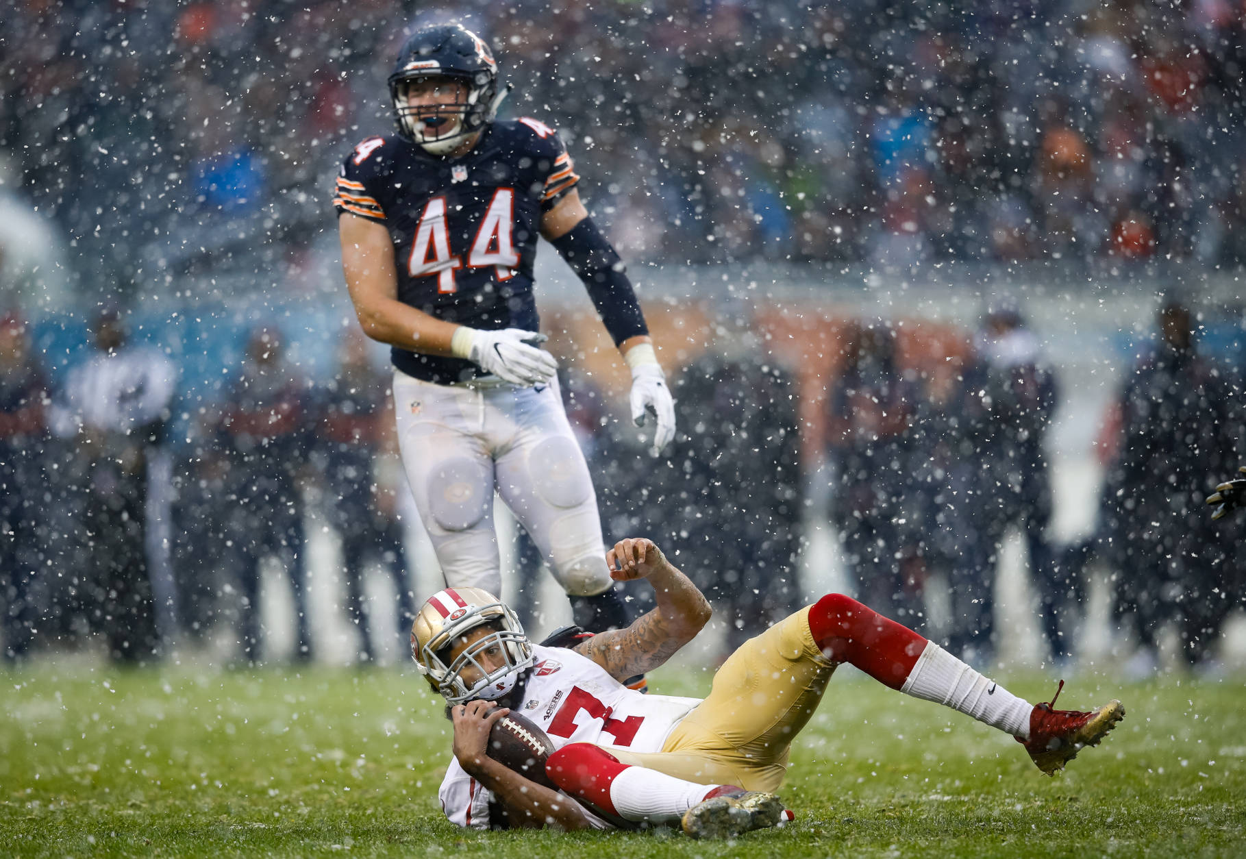 CHICAGO, IL - DECEMBER 04:   Quarterback Colin Kaepernick #7 of the San Francisco 49ers lays in front of  Nick Kwiatkoski #44 of the Chicago Bears in the third quarter at Soldier Field on December 4, 2016 in Chicago, Illinois.  (Photo by Joe Robbins/Getty Images)