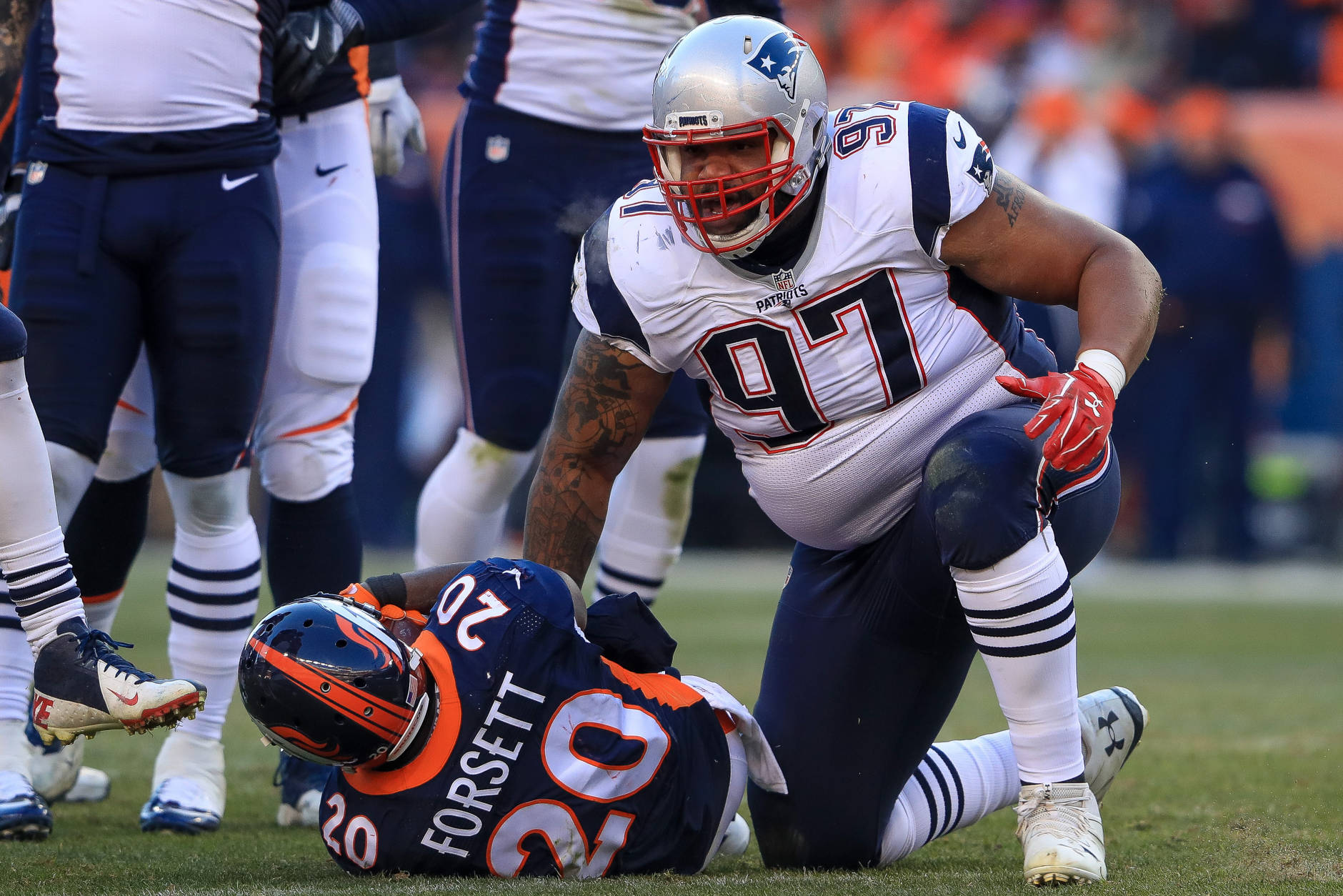 DENVER, CO - DECEMBER 18:  Defensive tackle Alan Branch #97 of the New England Patriots stands up after tackling running back Justin Forsett #20 of the Denver Broncos at Sports Authority Field at Mile High on December 18, 2016 in Denver, Colorado. (Photo by Sean M. Haffey/Getty Images)
