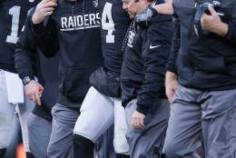 OAKLAND, CA - DECEMBER 24:  Derek Carr #4 of the Oakland Raiders is helped off the field after injuring his right leg during their NFL game against the Indianapolis Colts at Oakland Alameda Coliseum on December 24, 2016 in Oakland, California.  (Photo by Brian Bahr/Getty Images)