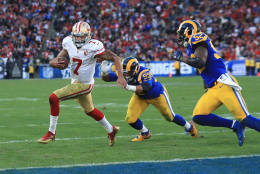 LOS ANGELES, CA - DECEMBER 24:  Colin Kaepernick #7 of the San Francisco 49ers rushes for a 13-yard touchdown during the fourth quarter as Aaron Donald #99 and Alec Ogletree #52 of the Los Angeles Rams attempt to tackle him at Los Angeles Memorial Coliseum on December 24, 2016 in Los Angeles, California.  (Photo by Sean M. Haffey/Getty Images)