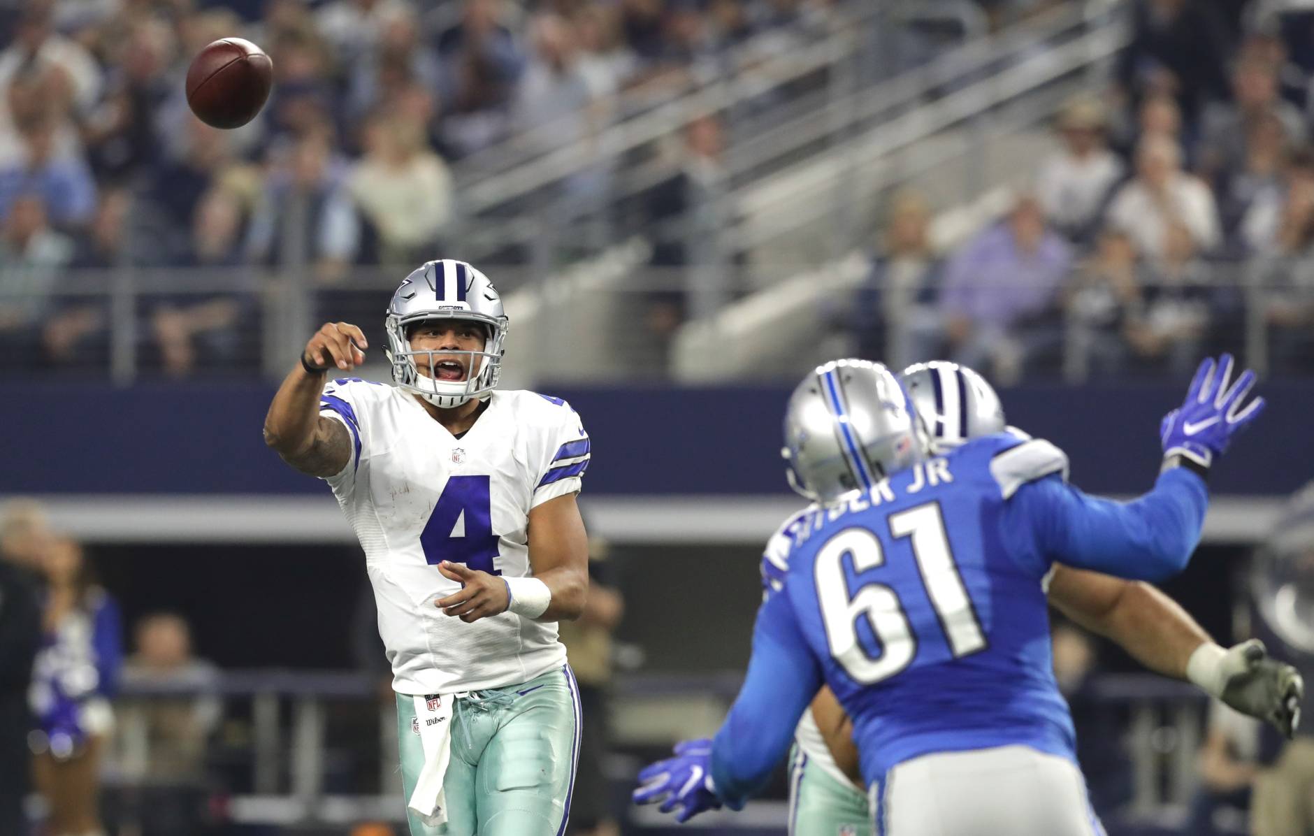ARLINGTON, TX - DECEMBER 26: Dak Prescott #4 of the Dallas Cowboys throws as Kerry Hyder #61 of the Detroit Lions defends during the first half at AT&amp;T Stadium on December 26, 2016 in Arlington, Texas. (Photo by Ronald Martinez/Getty Images)
