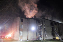 Firefighters battle an apartment building fire at 7800 Hanover Parkway in Greenbelt early Wednesday morning. Thirty-one people were displaced because of the fire. (Courtesy PGFD/Jim Davis)