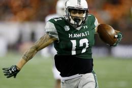 Hawaii wide receiver Keelan Ewaliko (12) makes the winning touchdown over Massachusetts during the forth quarter at the NCAA college football game on Saturday, Nov. 26, 2016, in Honolulu. Hawaii defeated Massachusetts 46-40. (AP Photo/Marco Garcia)
