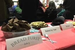 Several tables were stocked with food and other treats at the 100th anniversary of the Cleveland Park firehouse on Sunday, Dec. 4, 2016. (WTOP/Liz Anderson)