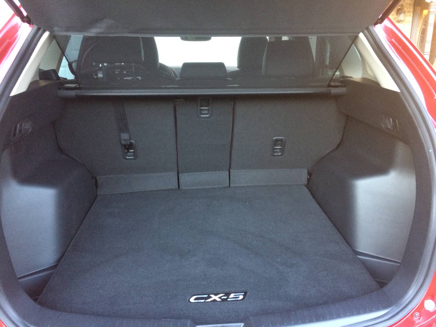 Cargo space is ample, and the rear seats fold nearly flat, adding to the utility of this Mazda. (WTOP/Mike Parris)